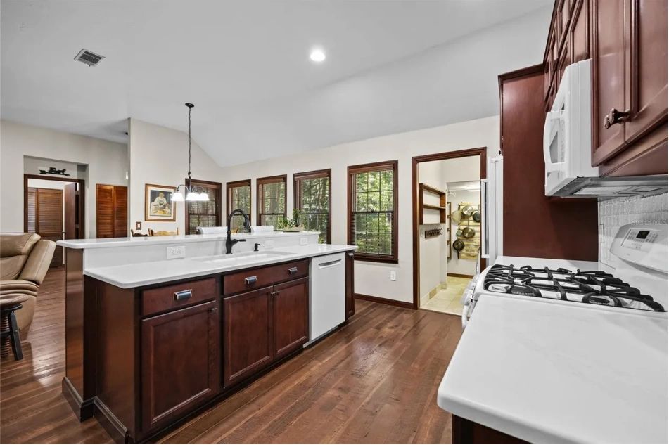 Dark cherry-wood kitchen in the ranch-style Gainesville property